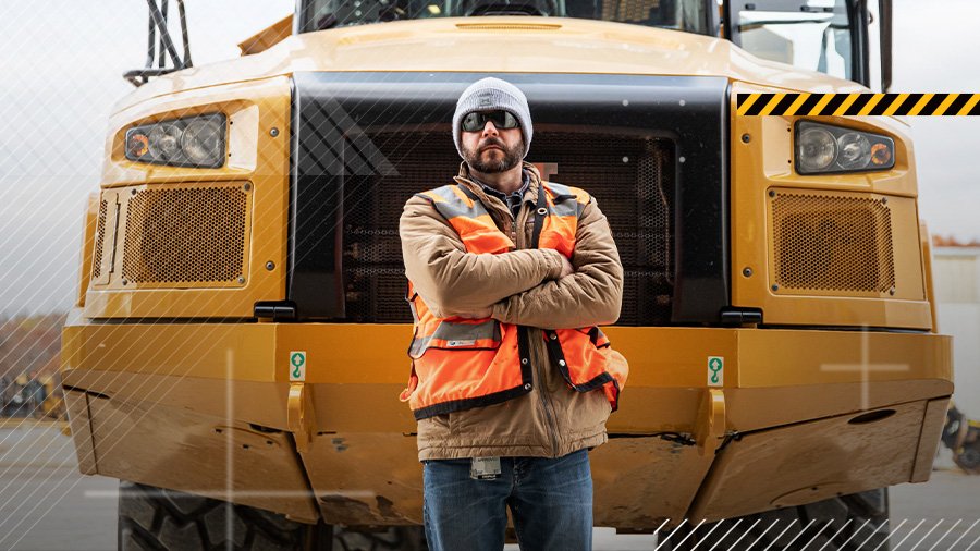 Operator in front of articulated truck