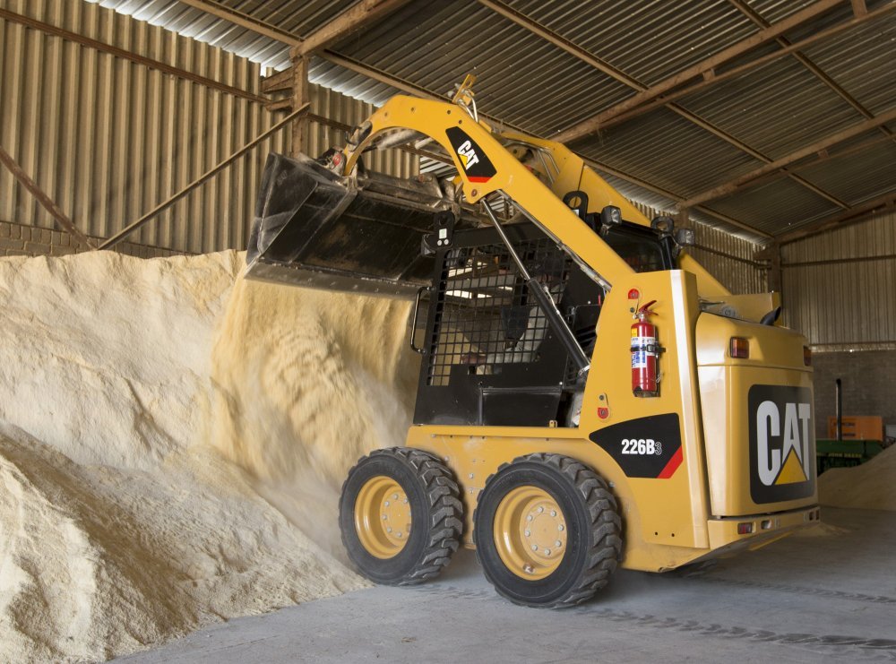 Skid Steer with Auger Putting In Fence