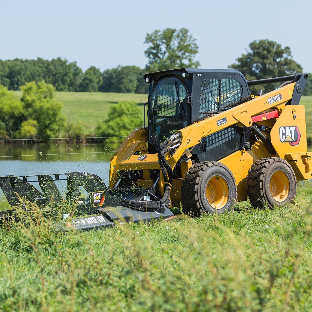 Skid Steer Mowing Field by Pond