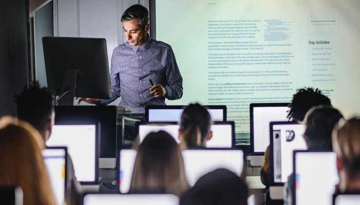 Teacher instructing classroom of students